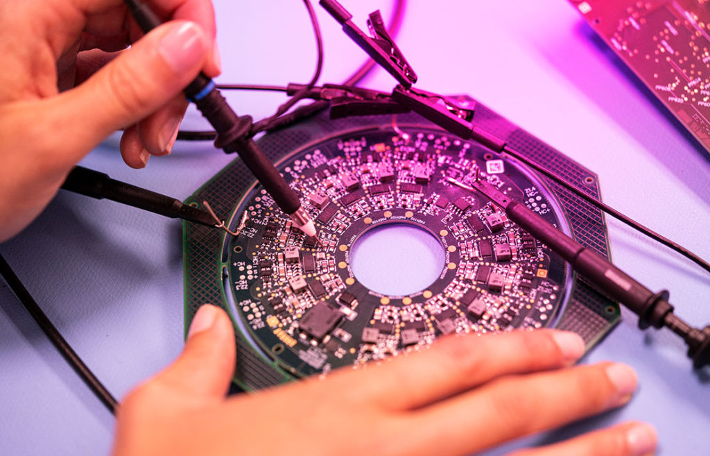 An employee of DIALUNOX who solders a circuit board