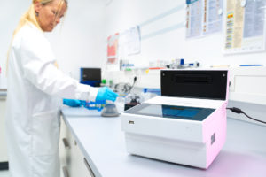 Tube scanner is the lab with an employee in the background