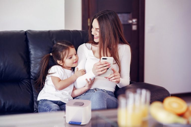 woman and daughter sitting on a sofa using the dialunox smart home lab